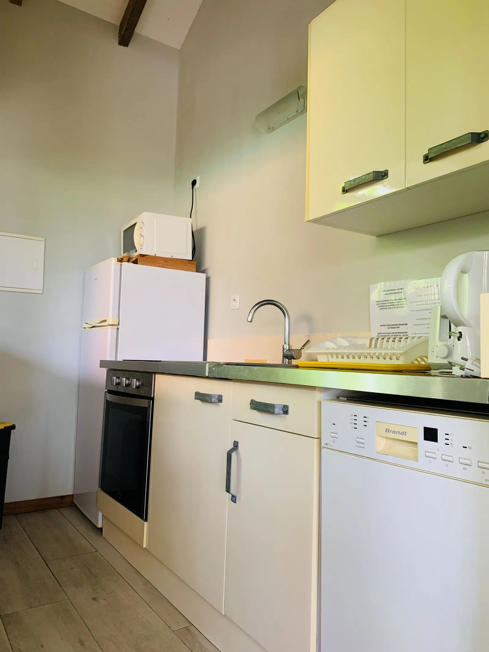 Cuisine équipée avec four, plaque, lave-vaisselle et réfrigérateur